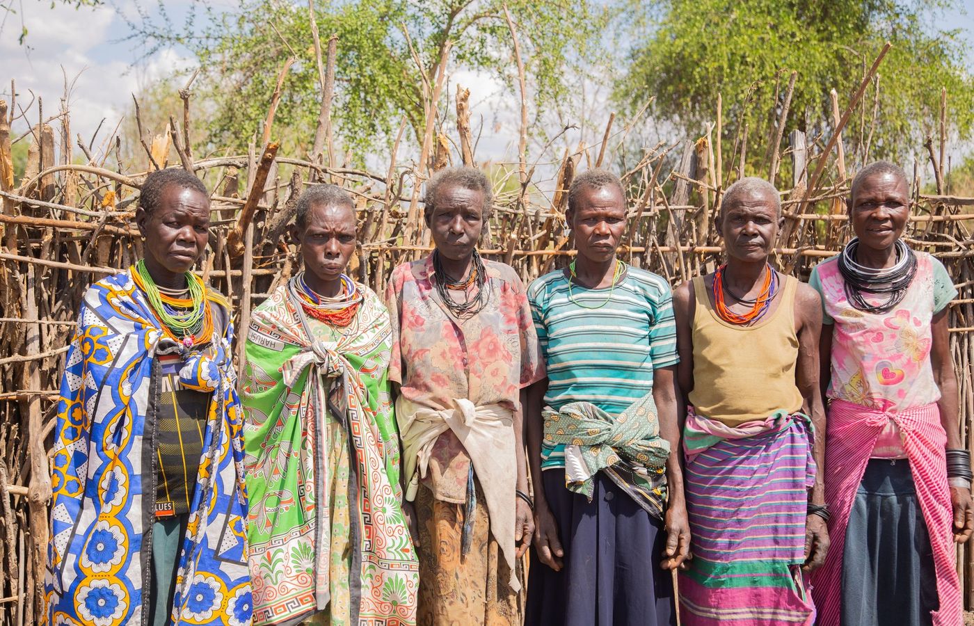 Women standing together outdoors: Migration, Protection and GEDSI